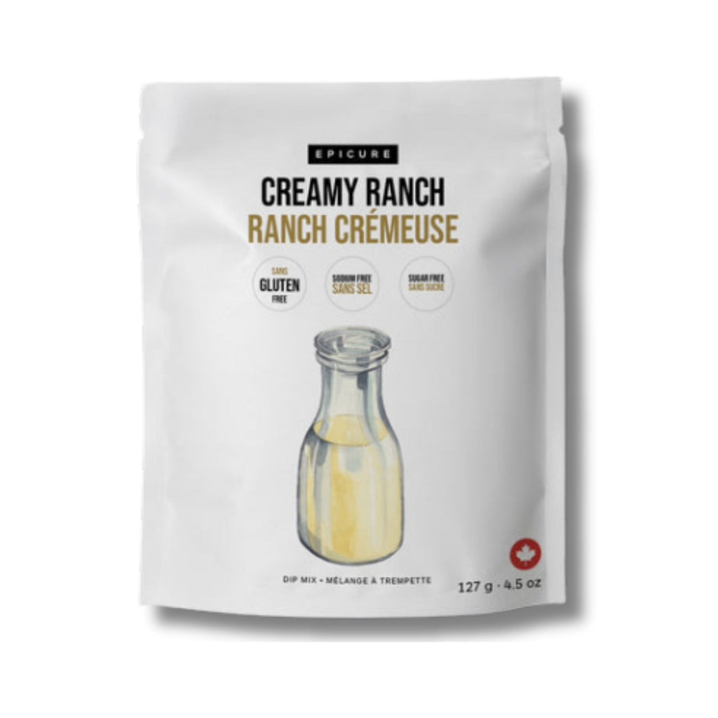A white stand-up pouch of Epicure Creamy Ranch Ranch Crémeuse dip mix, featuring a graphic of a glass bottle with pale yellow dip inside and text indicating gluten free, sugar free, and sodium free.