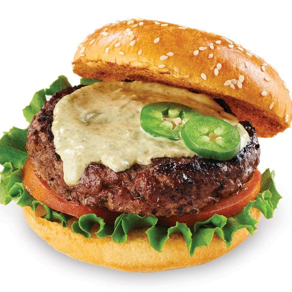 A Kickin' Ja;apeno hamburger with a grilled beef patty topped with melted cheese and sliced jalapeño peppers, served on a sesame seed bun with lettuce and tomato, isolated on a white background.