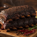 Two stacked racks of cooked pork ribs with a dark, crispy, seasoned exterior, garnished with red chili peppers, rosemary sprigs, and scattered coffee beans on a wooden cutting board.