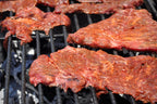 Beef marinated with Carne Asada on a grill 