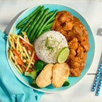 A top-down view of a Chicken Madras Curry on a white wooden table, featuring white rice, green beans, mixed vegetables, and two pieces of toast, with a turquoise napkin and blue-and-white patterned chopsticks nearby.