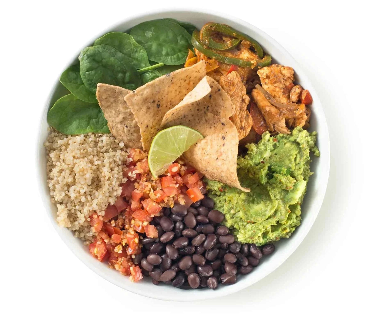 Vibrant bowl of salad with tortilla chips, guacamole, and vegetables on a white background
