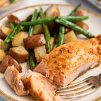 Sliced salmon with potatoes and green beans on a plate
