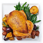Roasted chicken with vegetables on a white plate