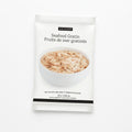 A single packet of Epicure Seafood Gratin hot dip mix, featuring a white package with a photo of the creamy, speckled prepared food in a bowl and black text.
