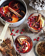 A small pot of red wine with cinnamon, star anise and pomegranate seeds - A Spice Affair