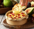 Baked Pizza Hot Dip Mix Epicure dish with pepperoni being dipped into by a piece of bread, surrounded by figs and pears.
