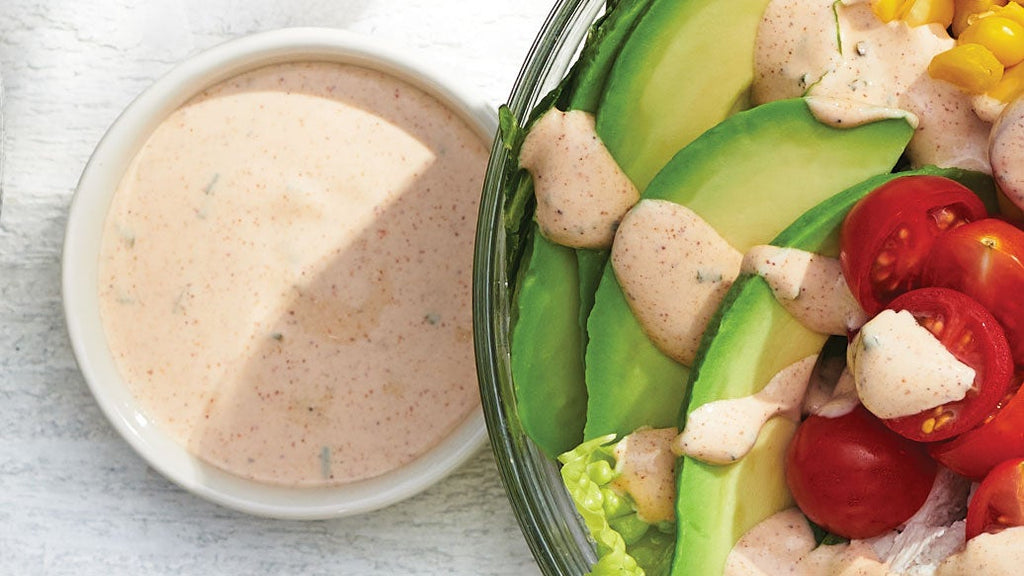 Prepared Epicure Southwest Ranch Dressing with salad bowl on a marble background