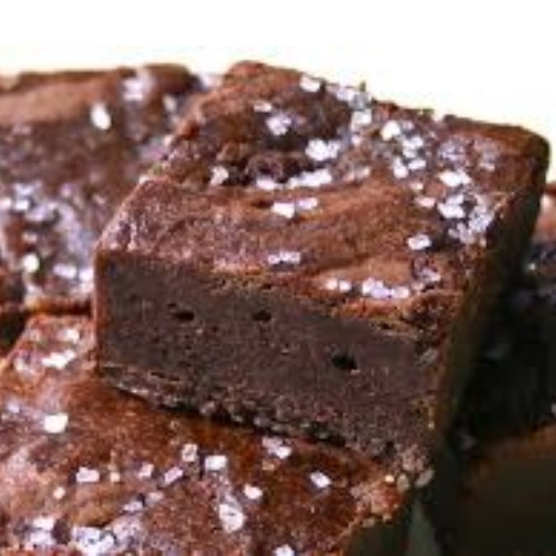 Chocolate brownies with sea salt on a white background